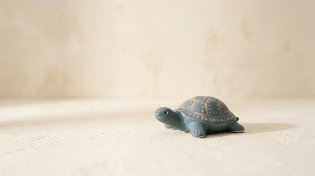 Small ceramic turtle figurine in slate blue-grey